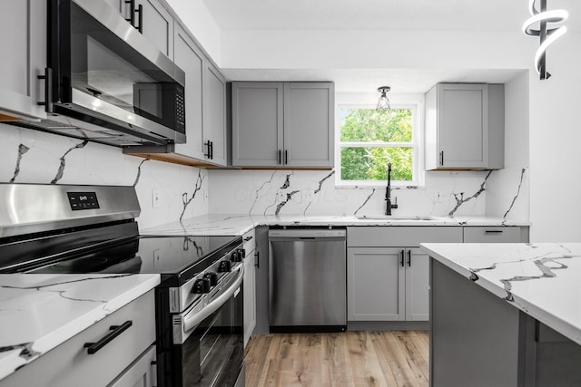 2840 Harnet Ct, Columbus, OH 43231 - kitchen with appliances with stainless steel finishes, gray cabinets, and light wood finished floors