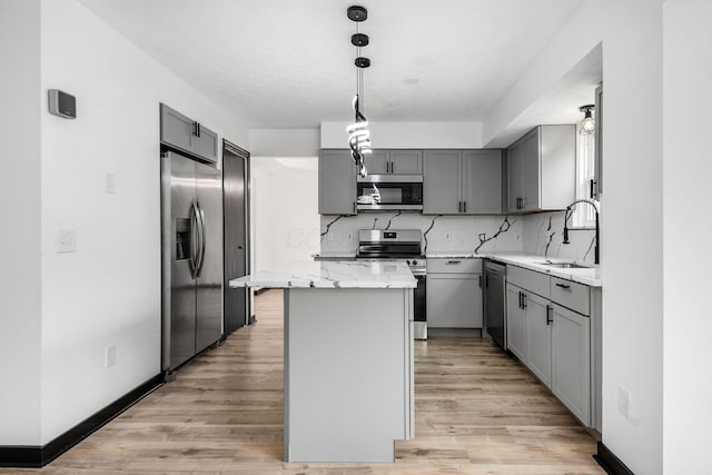 2840 Harnet Ct, Columbus, OH 43231 - kitchen featuring stainless steel appliances, gray cabinetry, a center island, and light wood-style flooring