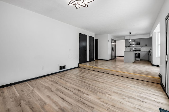 2840 Harnet Ct, Columbus, OH 43231 - unfurnished living room featuring light wood finished floors
