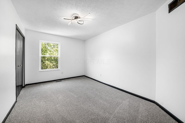 2840 Harnet Ct, Columbus, OH 43231 - unfurnished room featuring carpet flooring and a textured ceiling