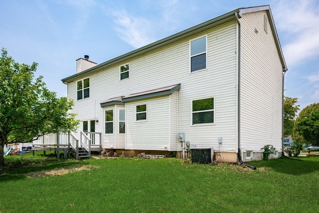 2840 Harnet Ct, Columbus, OH 43231 - back of property with a chimney, a lawn, and a deck