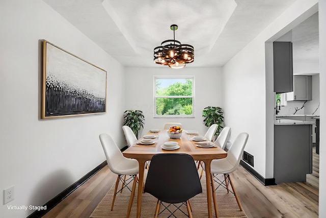 2840 Harnet Ct, Columbus, OH 43231 - dining space featuring light wood-style flooring and a chandelier