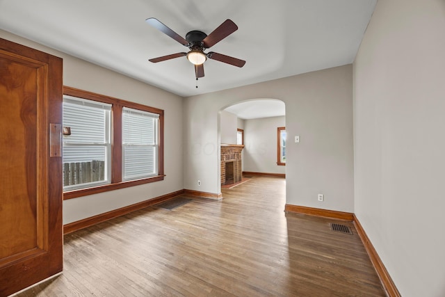 685 S Hague Ave, Columbus, OH 43204 - unfurnished room featuring arched walkways, healthy amount of natural light, wood finished floors, and ceiling fan