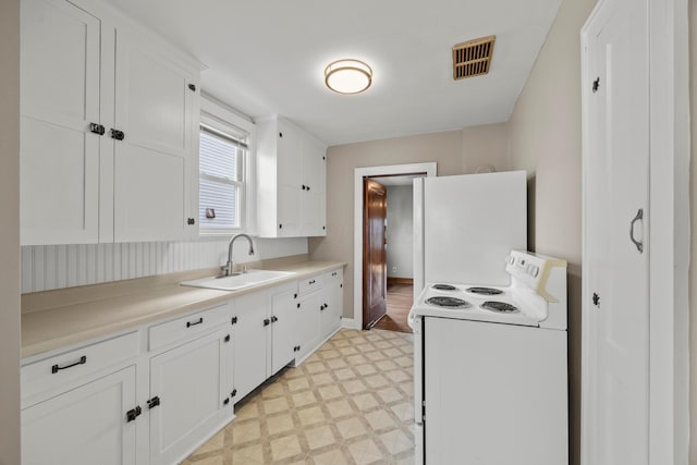 685 S Hague Ave, Columbus, OH 43204 - kitchen featuring white appliances, light floors, white cabinets, and light countertops
