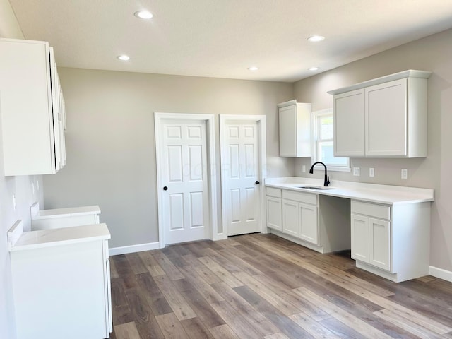 32352 Lilac Ln, Logan, OH 43138 - kitchen featuring wood finished floors, light countertops, recessed lighting, and white cabinetry