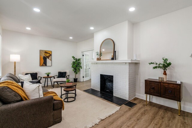1233 Oakwood Ave, Columbus, OH 43206 - living room featuring wood finished floors, a fireplace, and recessed lighting