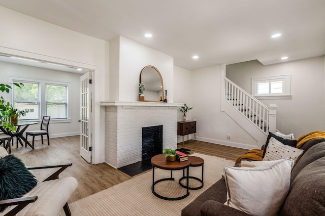 1233 Oakwood Ave, Columbus, OH 43206 - living area featuring wood finished floors, recessed lighting, stairway, and a fireplace