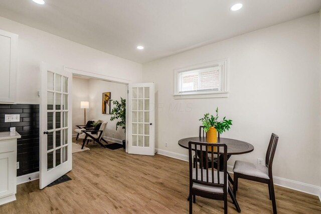 1233 Oakwood Ave, Columbus, OH 43206 - dining space featuring french doors, light wood finished floors, and recessed lighting