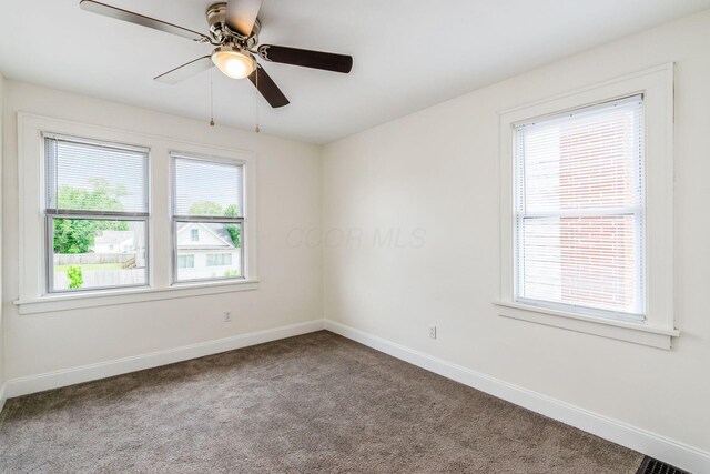 1233 Oakwood Ave, Columbus, OH 43206 - carpeted empty room with healthy amount of natural light and ceiling fan