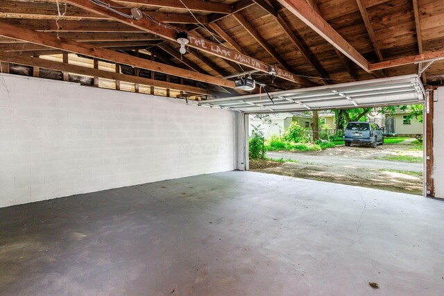 1233 Oakwood Ave, Columbus, OH 43206 - garage with concrete block wall and a garage door opener