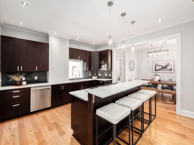 248 E Whittier St, Columbus, OH 43206 - kitchen with stainless steel appliances, light countertops, a kitchen bar, tasteful backsplash, and recessed lighting
