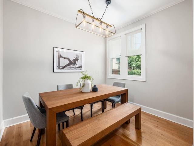 248 E Whittier St, Columbus, OH 43206 - dining space featuring ornamental molding, light wood-type flooring, and a chandelier