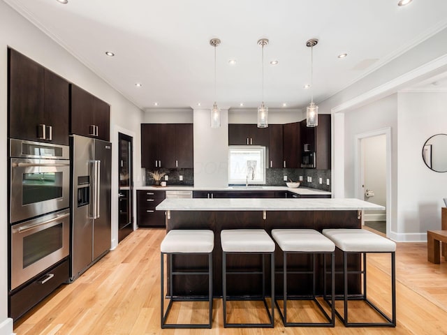 248 E Whittier St, Columbus, OH 43206 - kitchen with stainless steel appliances, light countertops, dark brown cabinets, backsplash, and recessed lighting