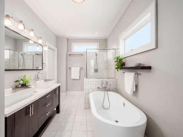 248 E Whittier St, Columbus, OH 43206 - full bathroom featuring a soaking tub, a shower stall, double vanity, crown molding, and tile patterned flooring