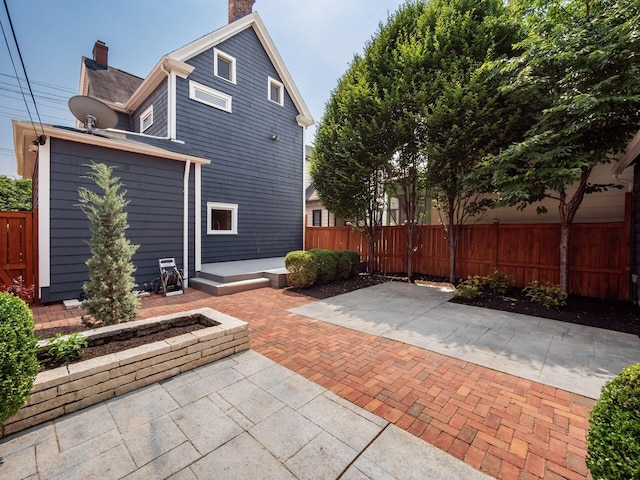 248 E Whittier St, Columbus, OH 43206 - back of property with a chimney and a patio