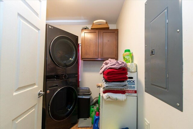 1935 Sedan Ave, Obetz, OH 43207 - laundry room featuring estacked washer and dryer, electric panel, and cabinet space