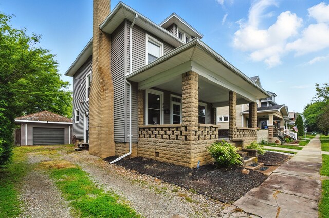 835 Rogers St, Bucyrus, OH 44820 - view of front of property with covered porch, a chimney, an outdoor structure, and a detached garage