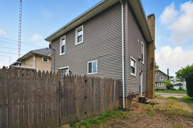 835 Rogers St, Bucyrus, OH 44820 - view of property exterior with a chimney