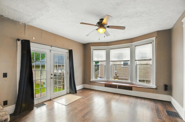 835 Rogers St, Bucyrus, OH 44820 - doorway featuring french doors, a ceiling fan, wood finished floors, and a textured ceiling