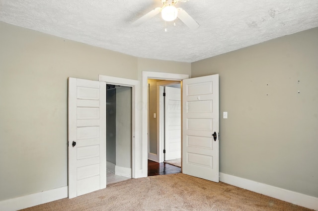 835 Rogers St, Bucyrus, OH 44820 - unfurnished bedroom featuring carpet, a textured ceiling, a closet, and a ceiling fan