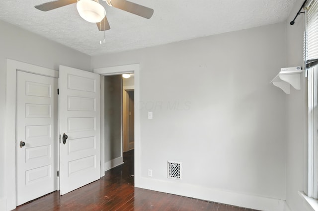 835 Rogers St, Bucyrus, OH 44820 - unfurnished bedroom featuring hardwood / wood-style flooring, a textured ceiling, and a ceiling fan