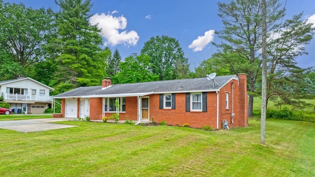 1508 W Hanley Rd, Mansfield, OH 44904 - view of front facade with a chimney, brick siding, a front lawn, and concrete driveway