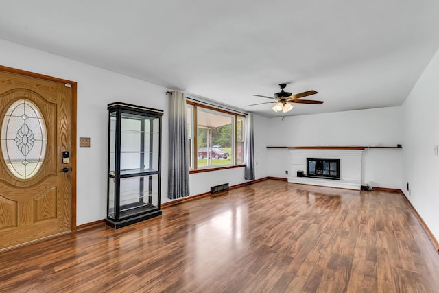 1508 W Hanley Rd, Mansfield, OH 44904 - unfurnished living room featuring wood finished floors, ceiling fan, and a glass covered fireplace