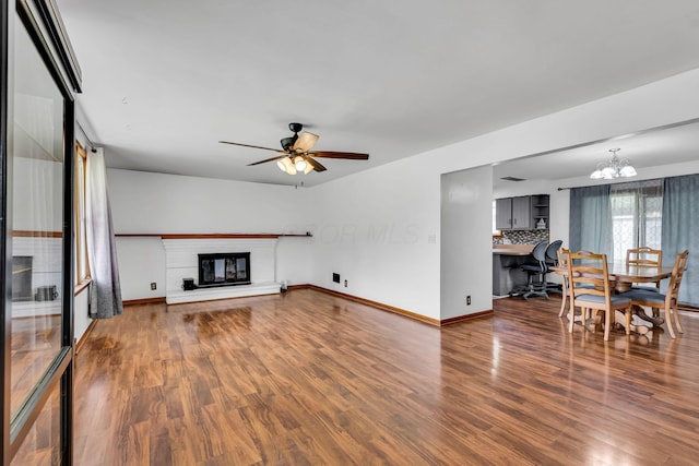 1508 W Hanley Rd, Mansfield, OH 44904 - living area featuring a chandelier, wood finished floors, a glass covered fireplace, and a ceiling fan
