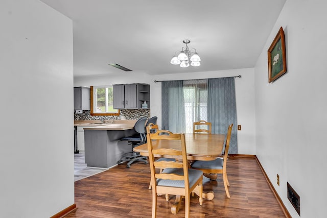 1508 W Hanley Rd, Mansfield, OH 44904 - dining space featuring a chandelier and dark wood-style floors