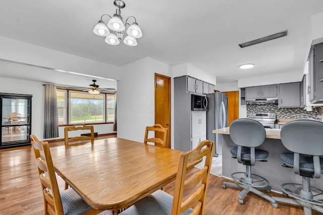 1508 W Hanley Rd, Mansfield, OH 44904 - dining room with light wood-type flooring, a chandelier, and ceiling fan