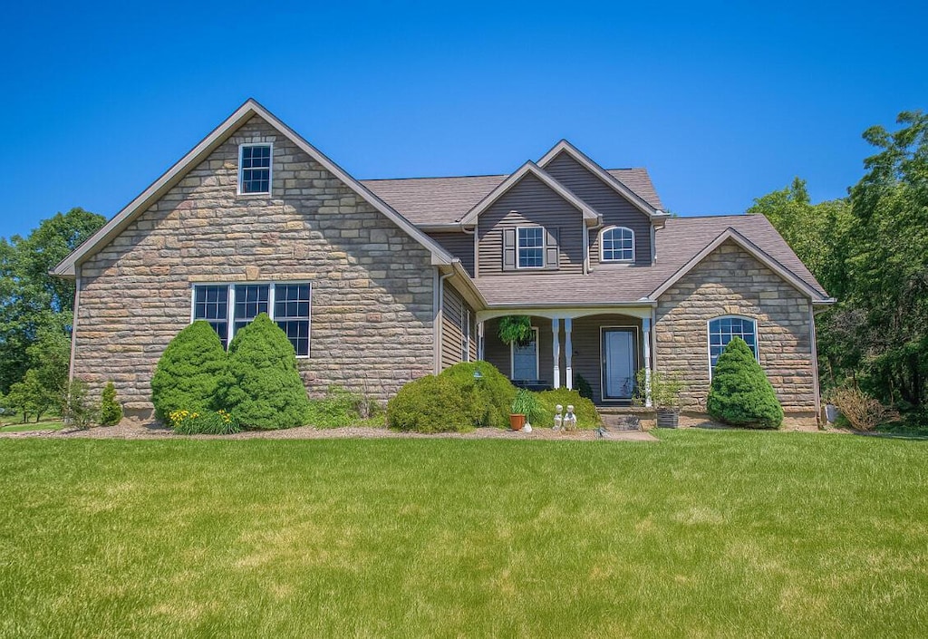 3180 Palmer Dr, Chandlersville, OH 43727 - view of front facade featuring stone siding and a front lawn