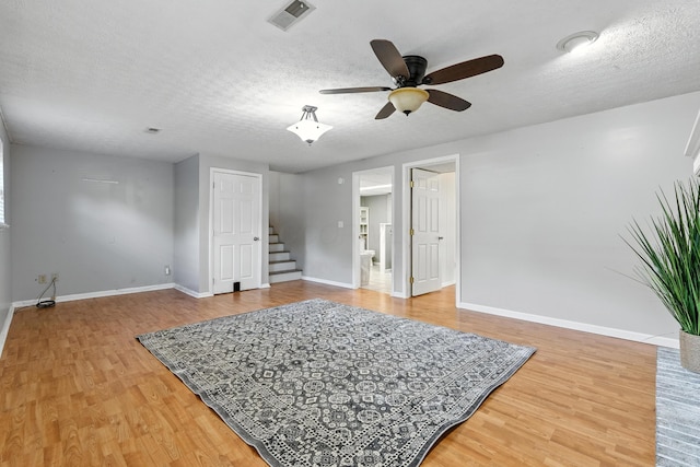 65 Jeffery Ln SE, Heath, OH 43056 - living room with stairway, light wood-type flooring, a ceiling fan, and a textured ceiling
