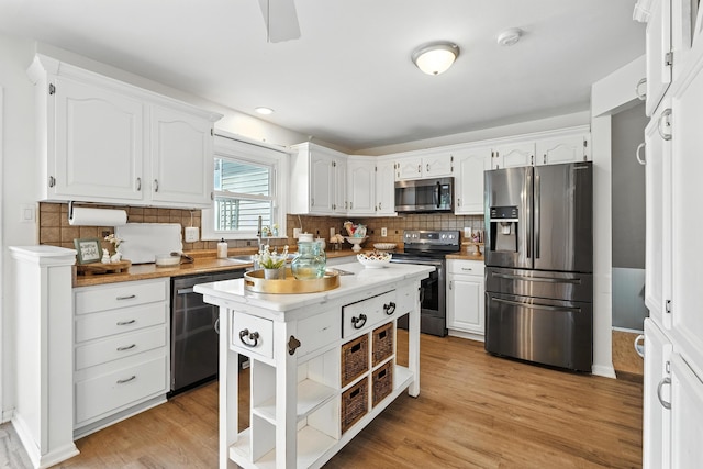 65 Jeffery Ln SE, Heath, OH 43056 - kitchen with stainless steel appliances, open shelves, white cabinets, and tasteful backsplash