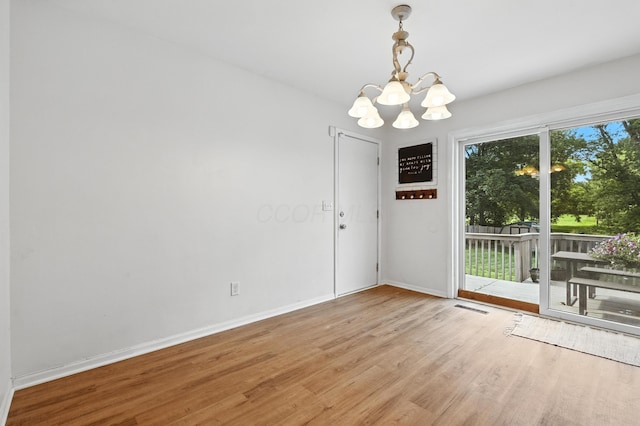 65 Jeffery Ln SE, Heath, OH 43056 - unfurnished dining area featuring a chandelier and wood finished floors