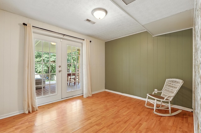 65 Jeffery Ln SE, Heath, OH 43056 - unfurnished room featuring light wood-type flooring, french doors, and a textured ceiling