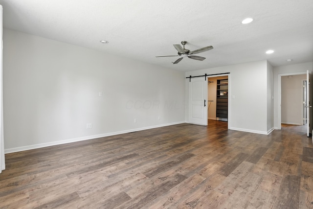65 Jeffery Ln SE, Heath, OH 43056 - unfurnished room with ceiling fan, a barn door, wood finished floors, and recessed lighting