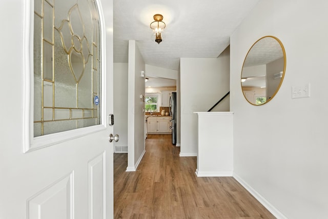 65 Jeffery Ln SE, Heath, OH 43056 - foyer featuring wood finished floors and baseboards