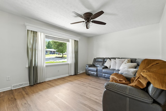 65 Jeffery Ln SE, Heath, OH 43056 - living room featuring wood finished floors, a ceiling fan, and a textured ceiling