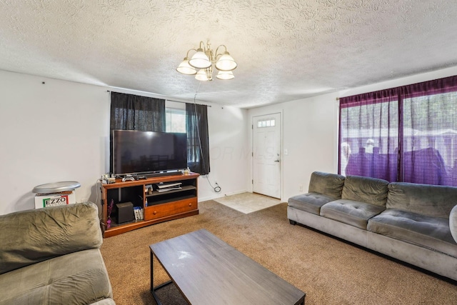 699 Cherry Hollow Rd Unit A, Columbus, OH 43228 - carpeted living room featuring a chandelier and a textured ceiling