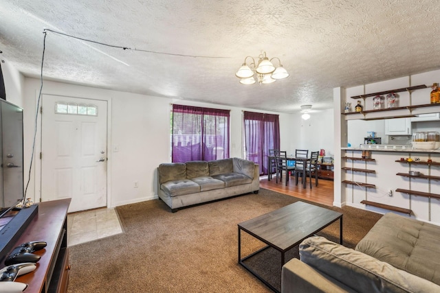 699 Cherry Hollow Rd Unit A, Columbus, OH 43228 - carpeted living area featuring a chandelier and a textured ceiling