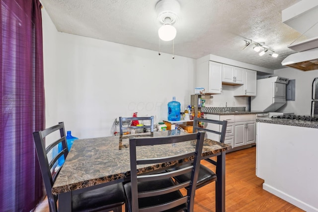 699 Cherry Hollow Rd Unit A, Columbus, OH 43228 - dining area featuring a textured ceiling and wood finished floors