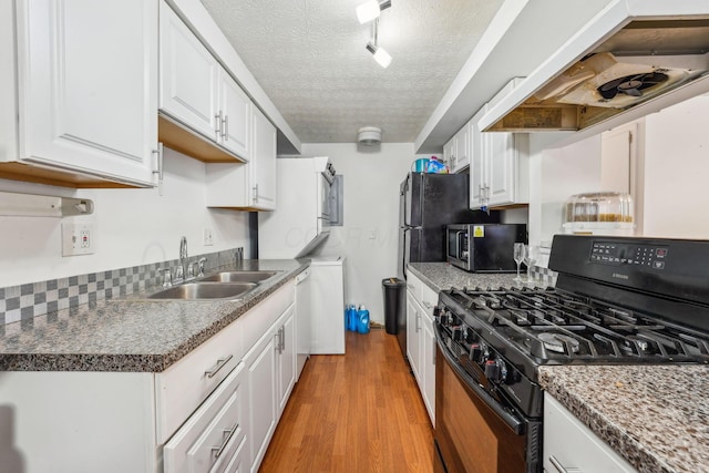 699 Cherry Hollow Rd Unit A, Columbus, OH 43228 - kitchen featuring black range with gas stovetop, white cabinetry, light wood-type flooring, a textured ceiling, and exhaust hood