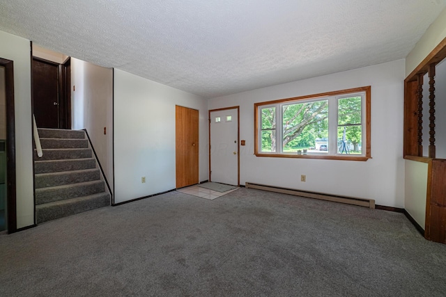 1892 County Road 170, Marengo, OH 43334 - unfurnished living room featuring a baseboard heating unit, carpet flooring, a textured ceiling, and stairs