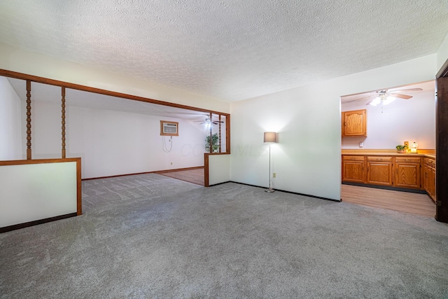 1892 County Road 170, Marengo, OH 43334 - below grade area with ceiling fan, light carpet, a wall mounted air conditioner, and a textured ceiling