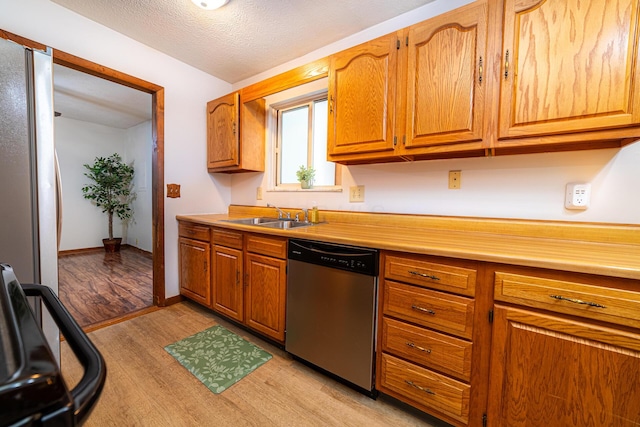 1892 County Road 170, Marengo, OH 43334 - kitchen with appliances with stainless steel finishes, light wood-type flooring, light countertops, and brown cabinets