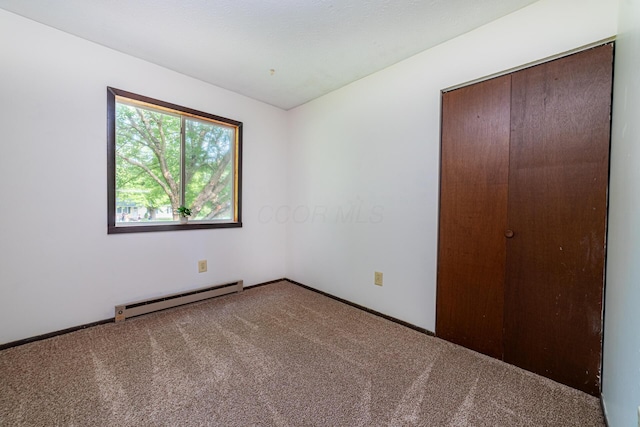 1892 County Road 170, Marengo, OH 43334 - unfurnished bedroom with baseboard heating and carpet flooring