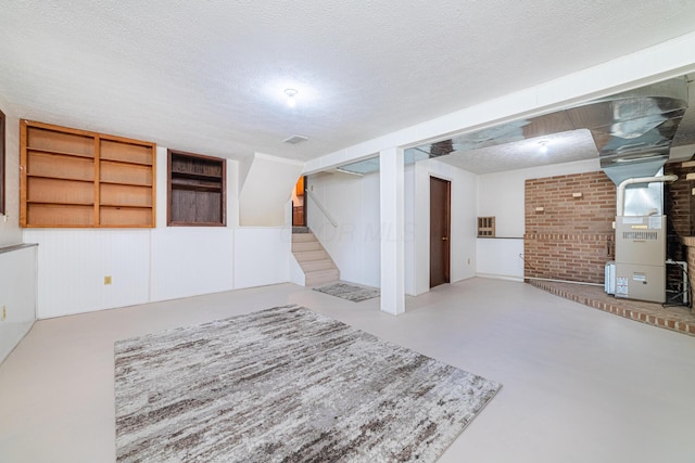 1892 County Road 170, Marengo, OH 43334 - finished below grade area with heating unit, stairs, and a textured ceiling