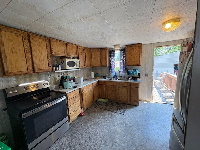 659 E Mark St, Marion, OH 43302 - kitchen with stainless steel appliances, brown cabinets, healthy amount of natural light, and light countertops