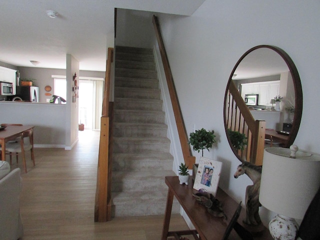 6038 Phar Lap Dr, New Albany, OH 43054 - stairway featuring wood finished floors