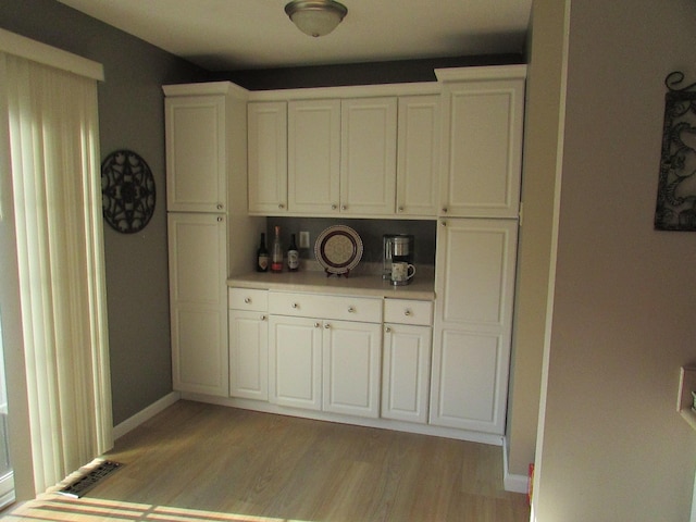 6038 Phar Lap Dr, New Albany, OH 43054 - kitchen featuring light wood-style floors, light countertops, and white cabinetry